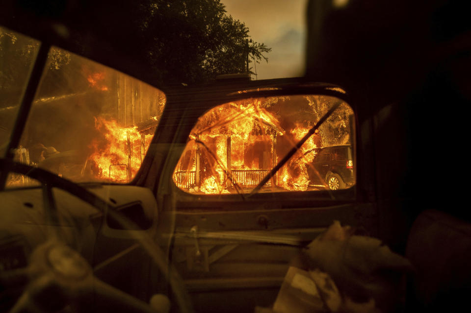 Fire consumes a home as the Sugar Fire, part of the Beckwourth Complex Fire, tears through Doyle, Calif., on Saturday, July 10, 2021. Pushed by heavy winds, the fire came out of the hills and destroyed multiple residences in central Doyle. (AP Photo/Noah Berger)