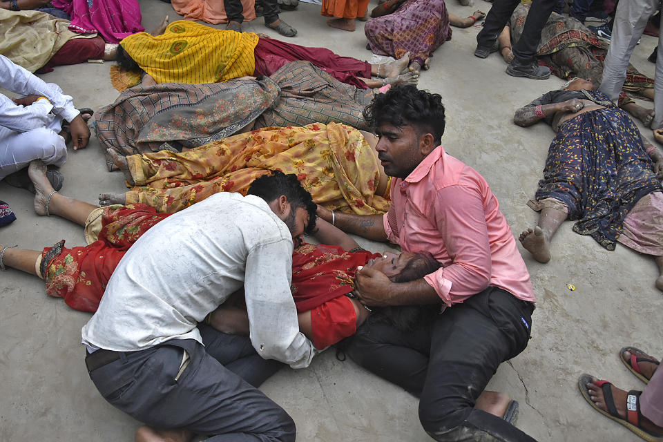 Men mourn as they hold the body of a stampede victim outside the Sikandrarao hospital in Hathras district of India, July 2, 2024. Severe overcrowding and a lack of exits contributed to a stampede at a religious festival that killed at least 121 people in northern India, authorities said. (AP Photo)