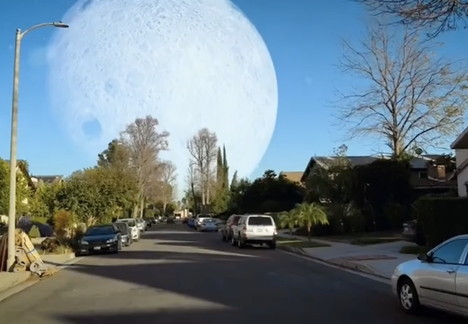 A huge moon filling the daylight sky in a suburb