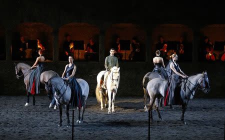 Horses and riders perform on stage during a dress rehearsal of Wolfgang Amadeus Mozart's cantata "Davide penitente" in Salzburg January 20, 2015. REUTERS/Dominic Ebenbichler