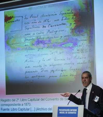 Historian Francisco Marin speaks about the search of the remains of Spanish writer Miguel de Cervantes in front of a projection of a historic document, in Madrid March 17, 2015. REUTERS/Andrea Comas