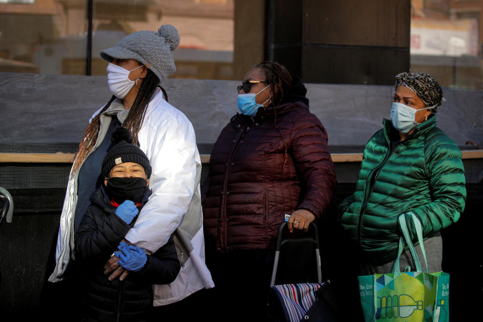 People line up to receive free holiday boxes of food from the Food Bank For New York City ahead of the Thanksgiving holiday, as the global outbreak of the coronavirus disease (COVID-19) continues, in the Harlem neighborhood of New York, U.S., November 16, 2020.  REUTERS/Brendan McDermid