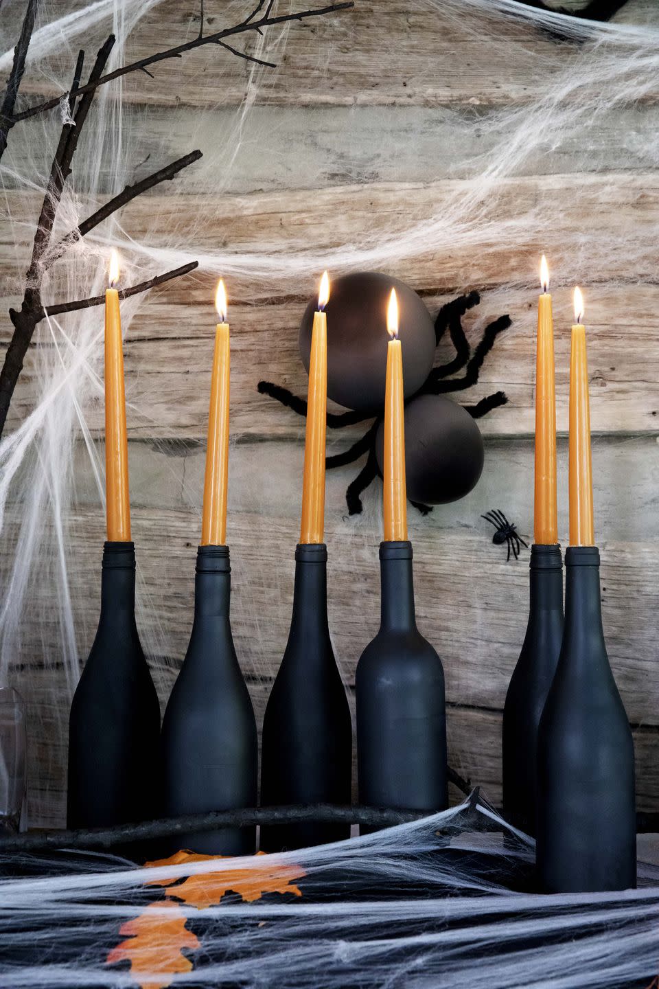 Orange Candles in Wine Bottles