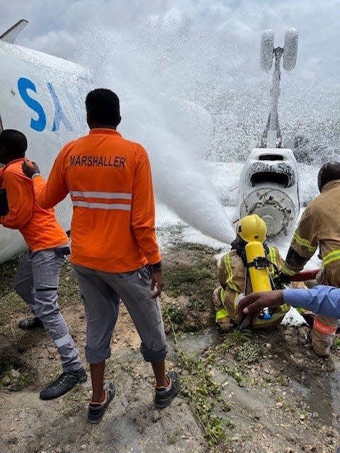 Somali first responders extinguish a fire on a Jubba Airlines aircraft Monday, July 18, 2022, at Mogadishu International Airport, Mogadishu, Somalia. Three 2nd Security Force Assistance Brigade soldiers from Fort Bragg helped first responders care for 16 injured passengers.
