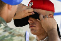 A presidential guard wipes the sweat from his colleague in front of the Tomb of the Unknown Soldier in Athens Greece, Tuesday, Aug. 3, 2021. Authorities in Greece have closed the Acropolis and other ancient sites during afternoon hours as a heatwave scorching the eastern Mediterranean continued to worsen. Temperatures reached 42 C (107.6 F) in parts of the Greek capital, as the extreme weather fueled deadly wildfires in Turkey and blazes across the region. (AP Photo/Michael Varaklas)