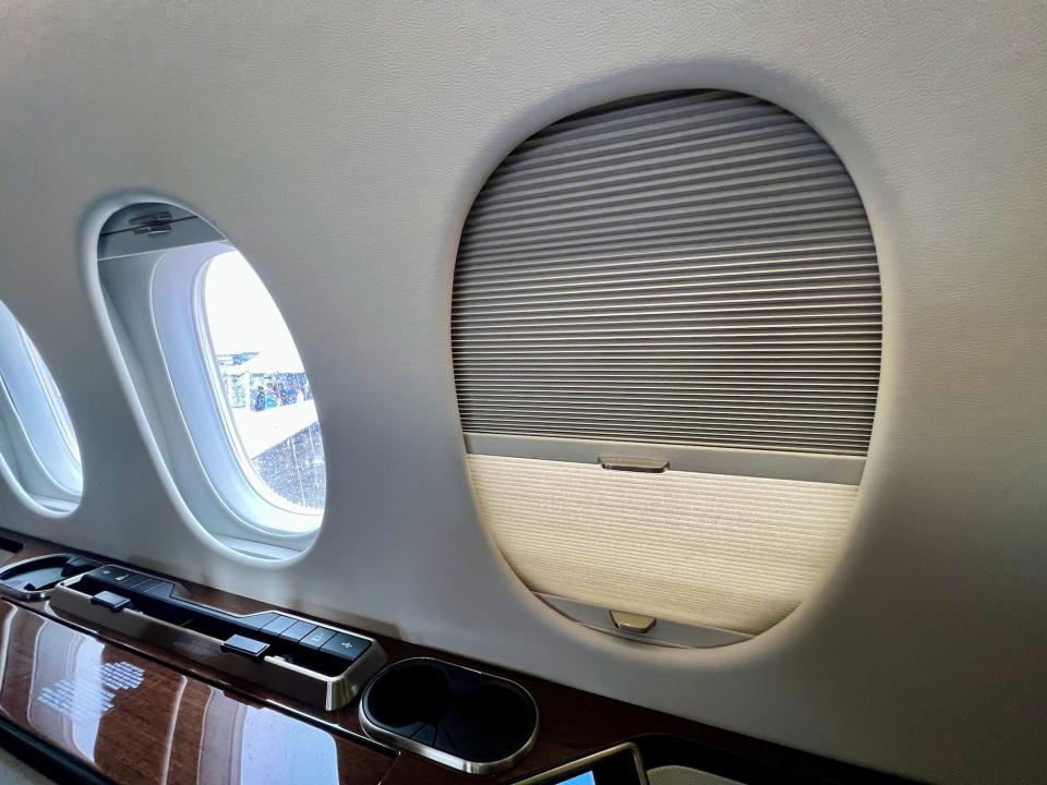 The adjustable window shade closed with the one next to it open.