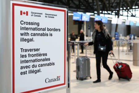 FILE PHOTO: A sign warning travellers about crossing international borders with cannabis is seen at the Ottawa International Airport in Ottawa, Ontario, Canada, October 15, 2018. REUTERS/Chris Wattie/File Photo