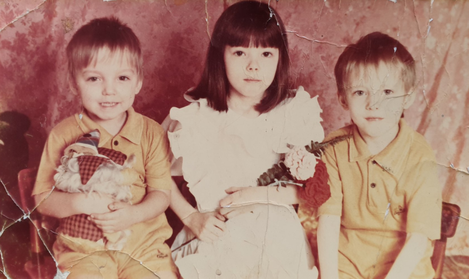Photo of the three siblings together as young children without Maxim, who was separated from the family in 2002.