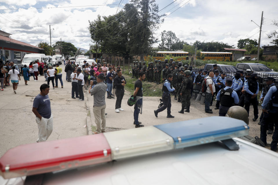 Police guard the entrance to the women's prison in Tamara, on the outskirts of Tegucigalpa, Honduras, Tuesday, June 20, 2023. A riot at the women's prison northwest of the Honduran capital has left at least 41 inmates dead, most of them burned to death, a Honduran police official said. (AP Photo/Elmer Martinez)
