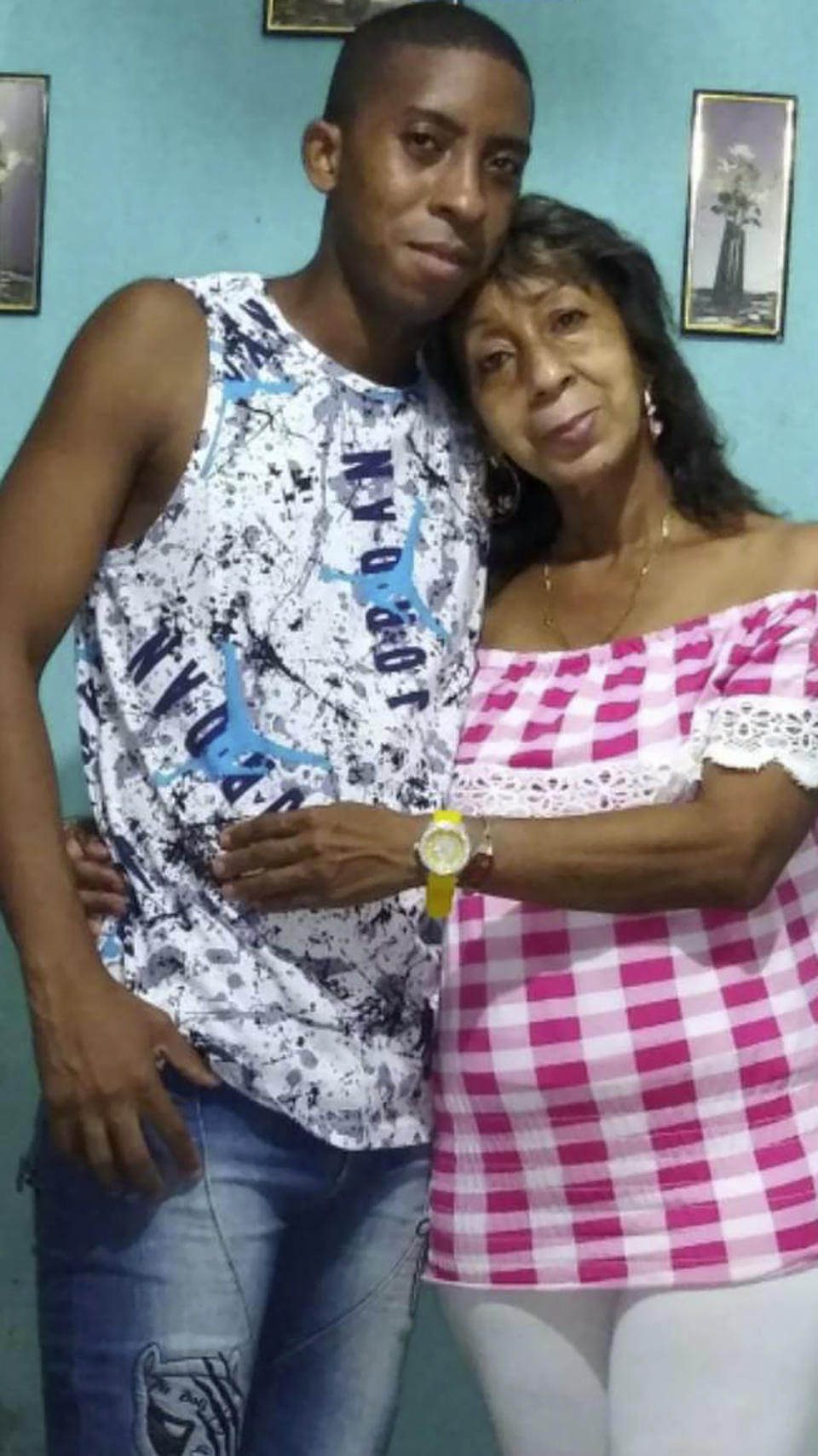 In this undated handout photo provided by Pedro Yudel Bruzon, Bruzon, left, poses with his mother, Teresa Acosta, in Havana. Bruzon is looking for someone to vouch for him as a financial sponsor under a U.S. asylum program to work in the United States for two years, now expanded to include Cubans like himself, as well as Nicaraguans and Haitians. (Pedro Yodel Bruzon via AP)