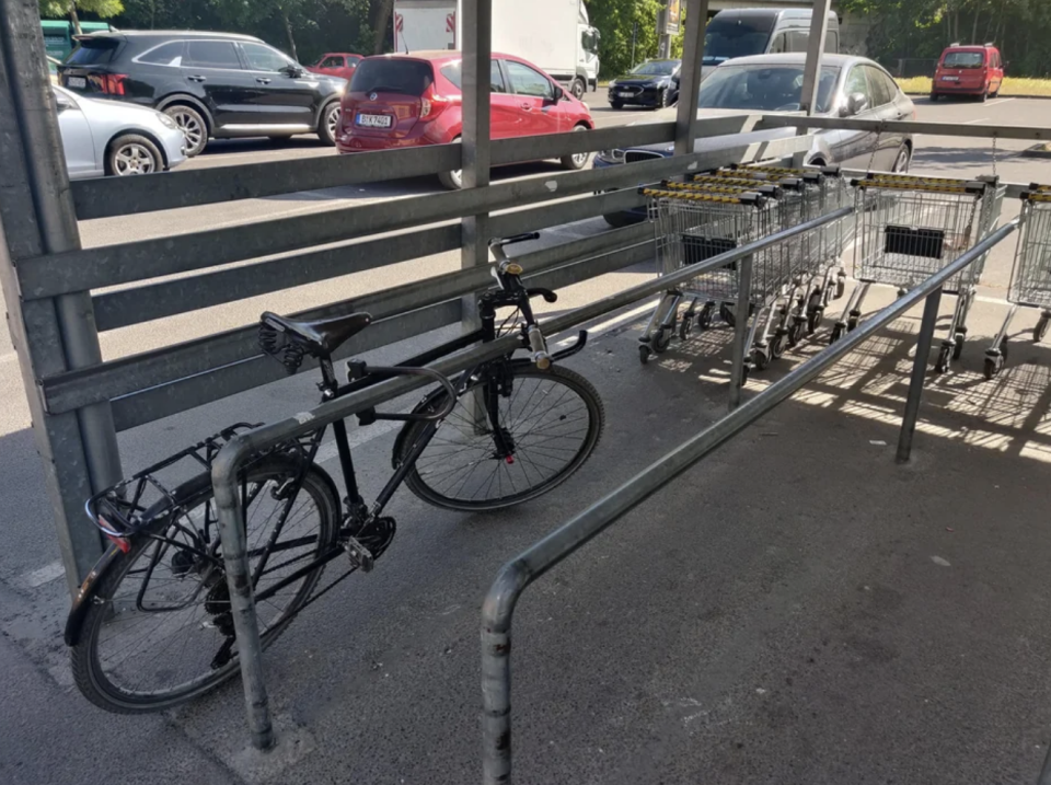 A person who locked their bike, blocking people from getting grocery carts