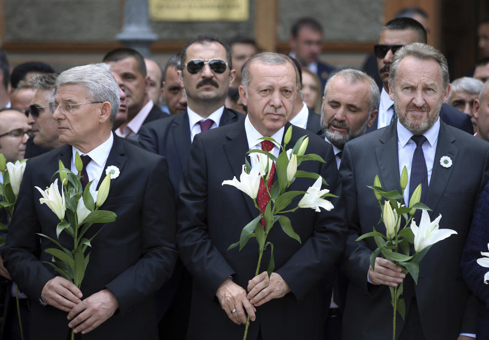 Turkish President Recep Tayyip Erdogan, center, Sefik Dzaferovic, Muslim member of Bosnian presidency, left, and Bakir Izetbegovic, the son of late Bosnian president Alija Izetbegovic, attend an event in memory of Bosnian Muslims from the eastern Bosnian town of Srebrenica, who were killed during the war in the 1990s in the worst massacre in Europe since World War II., in Sarajevo, Bosnia, Tuesday, July 9, 2019. (Presidential Press Service via AP, Pool)