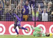 Orlando player Benji Michel celebrates in front of fans and fallen San Jose goalkeeper J.T. Marcinkowski, right, after scoring a goal during a MSL soccer match in Orlando, Fla., on Tuesday, June 22, 2021. (Stephen M. Dowell /Orlando Sentinel via AP)