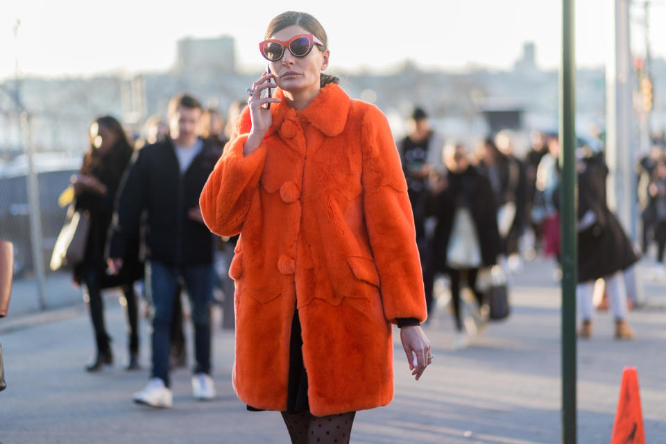 <p>If you prefer to wear fur during the winter, take a style cue from Giovanna Battaglia and opt for a bold colored faux version, accessorized with matching sunglasses. (Photo: Getty) </p>