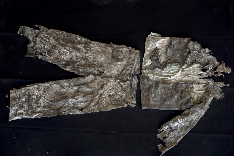 In this Thursday, March 26, 2019 photo, the clothes of a victim with monogram 'MG" embroidered into the shirt, photographed after the body was exhumed from a mass grave at the cemetery of Paterna, near Valencia, Spain, after archaeologists in Spain unearthed layers of human bones last year. DNA tests will be conducted in the hope of confirming the identities of those who disappeared eight decades ago, believed to be executed by the forces of Gen. Francisco Franco during and after the 1936-39 Spanish Civil War.(AP Photo/Emilio Morenatti)