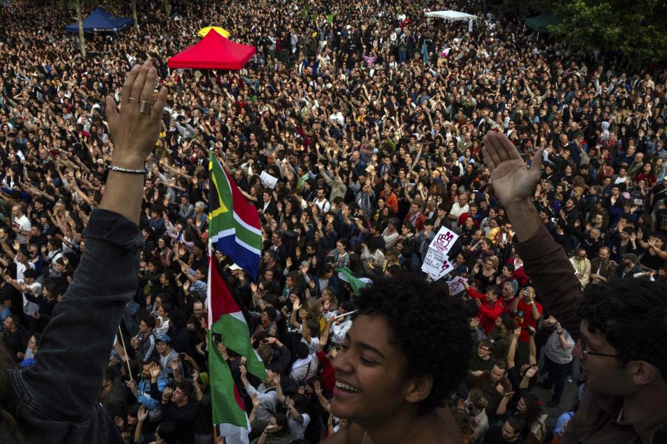 People gather at Republique plaza in a protest against the far-right, Wednesday, July 3, 2024, in Paris. (AP Photo/Louise Delmotte)