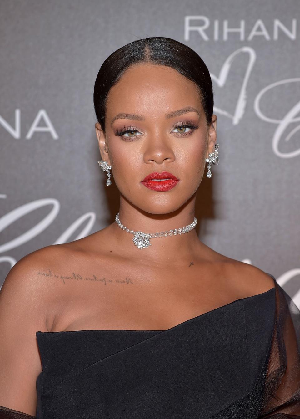 <p>Rihanna can now add luxury jewelry designer to her list of credits. The singer attended a dinner in honor of her Chopard collection during Cannes rocking a slicked-back bun, long lashes, matte red lips, and her own jewels, of course. (Photo: Getty Images) </p>