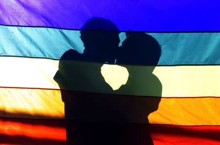 Men kiss each other during a gay protest in front at Nossa Senhora da Paz church in the Ipamena neighborhood in Rio de Janeiro, Brazil, August 3, 2003. REUTERS/Bruno Domingos/File Photo