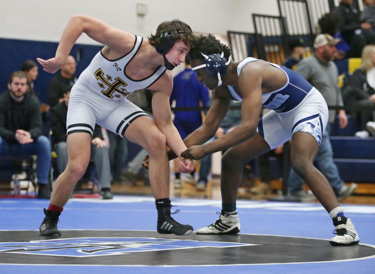 McQuaid's Casey Liess goes head-to-head with Eastridge's Nkodia Ndongala in a 160-pound match earlier this season.