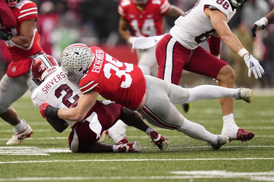 Nov 12, 2022; Columbus, Ohio, USA;  Ohio State Buckeyes linebacker Tommy Eichenberg (35) tackles Indiana Hoosiers running back Shaun Shivers (2) during the second half of the NCAA football game at Ohio Stadium. Ohio State won 56-14. Mandatory Credit: Adam Cairns-The Columbus Dispatch