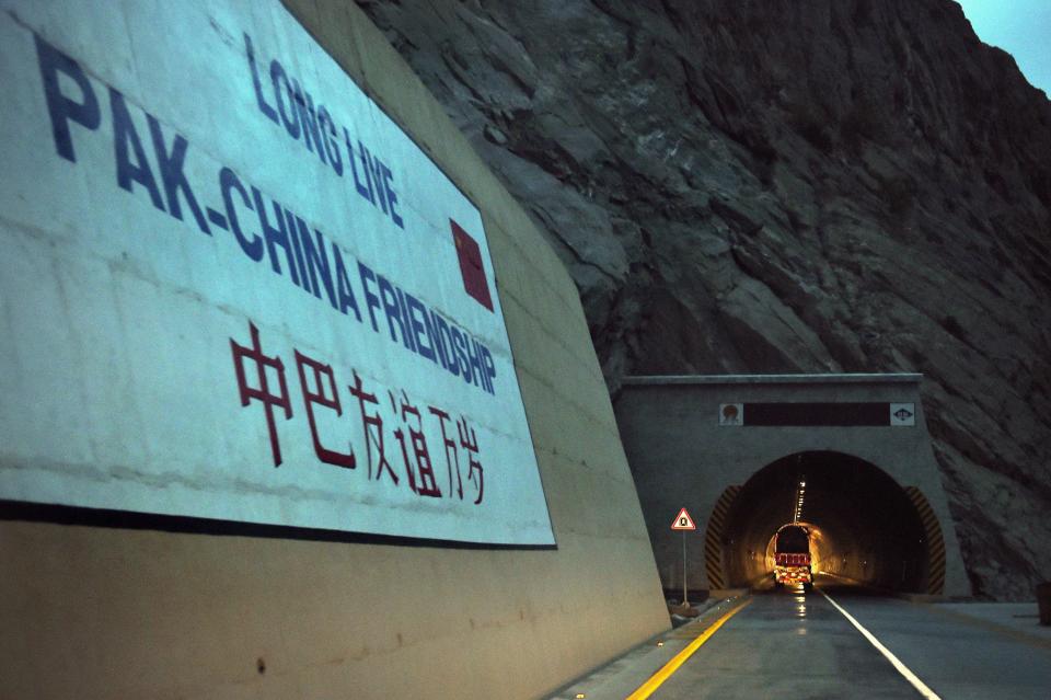 To go with story 'Pakistan-China-economy-transport, FEATURE' by Guillaume LAVALLÉE  In this photograph taken on September 29, 2015, a loaded truck travels through a newly built tunnel in northern Pakistan's Gojal Valley.  A glossy highway and hundreds of lorries transporting Chinese workers by the thousands: the new Silk Road is under construction in northern Pakistan, but locals living on the border are yet to be convinced they will receive more from it than dust.    AFP PHOTO / Aamir QURESHI        (Photo credit should read AAMIR QURESHI/AFP via Getty Images)