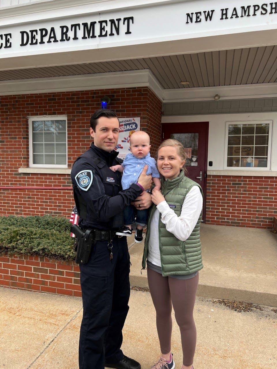 North Hampton police Sgt. Kyle Manlow poses for a photo with his wife Cody and son Theodore.