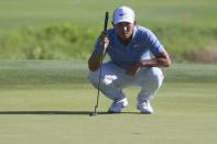 Apr 21, 2019; Hilton Head, SC, USA; C.T. Pan inspects the green of the eighteenth hole during the final round of the RBC Heritage golf tournament at Harbour Town Golf Links. Mandatory Credit: Joshua S. Kelly-USA TODAY Sports