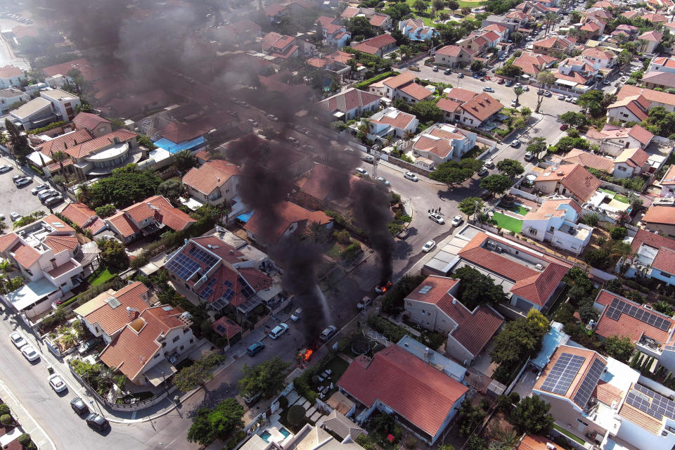 An aerial view shows vehicles on fire during a rocket attack from the Gaza Strip, in Ashkelon, southern Israel, October 7, 2023. / Credit: Reuters/Ilan Rosenberg