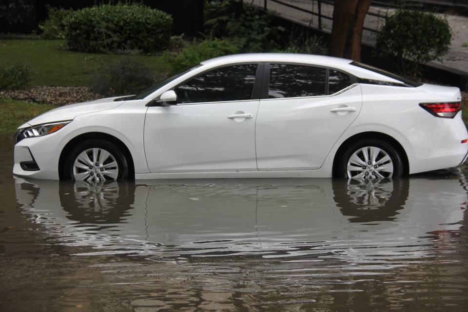 A car parked in a puddle on Crawford Avenue after a brief but heavy thunderstorm on Friday, July 28, 2023. 