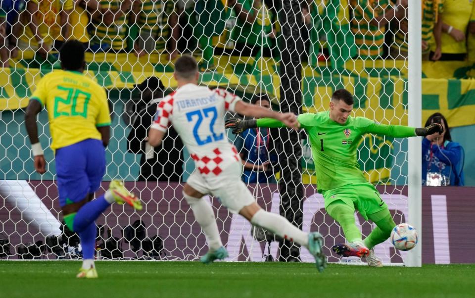 Croatia's goalkeeper Dominik Livakovic makes a save during the World Cup - AP Photo/Frank Augstein