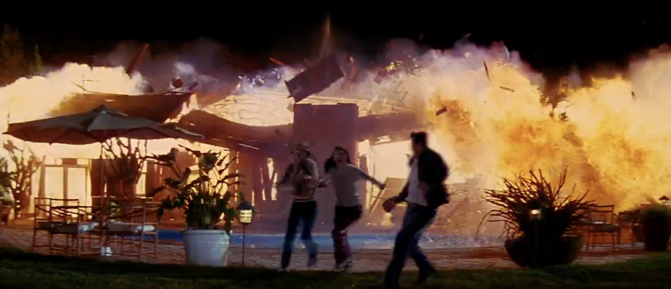 A house explodes as people run away from it