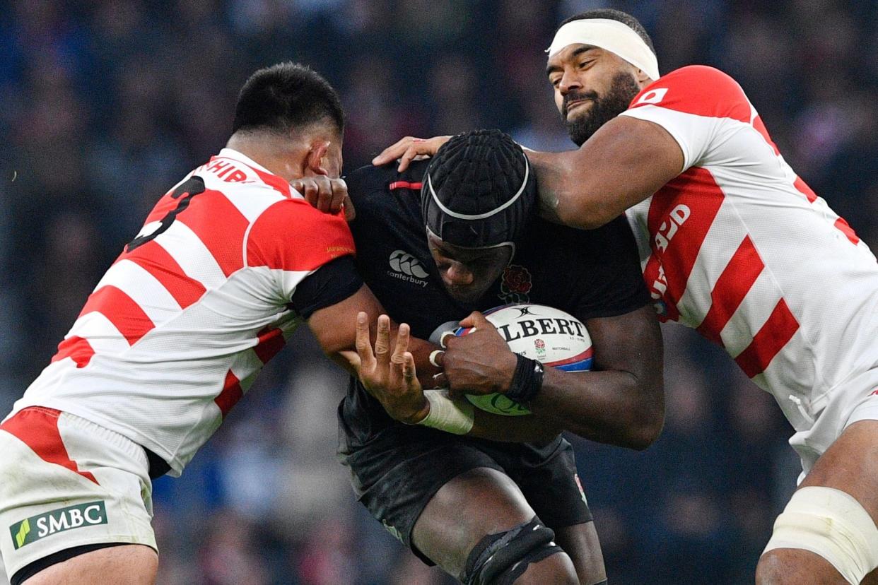 Sandwich course: Maro Itoje drives forward, despite the close attention of two Japan defenders at Twickenham on Saturday: EPA