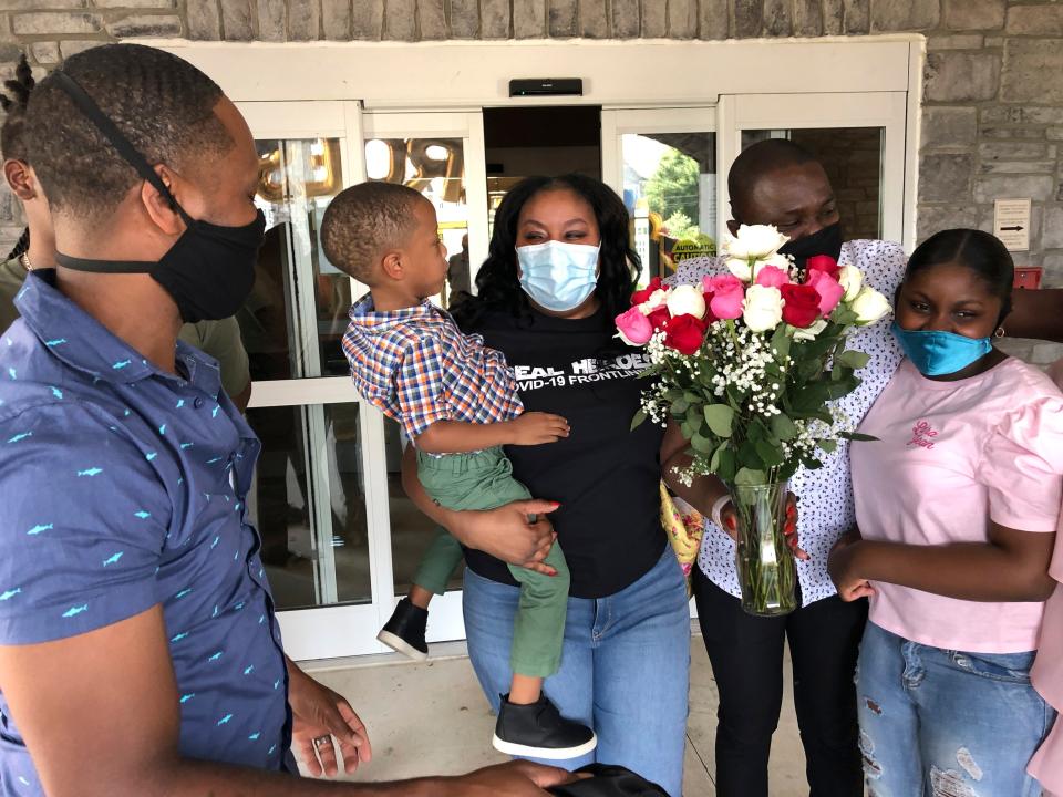 Teisha Roberts, center, a nursing director, is greeted by her family as she prepares to leave the Park Springs elder care facility in Stone Mountain, Ga., on June 13. Workers who agreed to live at Park Springs to keep its residents safe from the new coronavirus are back with their loved ones for the first time in nearly three months.