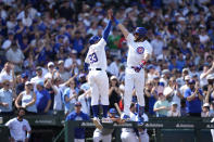 Chicago Cubs' Patrick Wisdom, right, celebrates his home run off Milwaukee Brewers relief pitcher Thyago Vieira with third base coach Willie Harris during the sixth inning of a baseball game Saturday, May 4, 2024, in Chicago. (AP Photo/Charles Rex Arbogast)