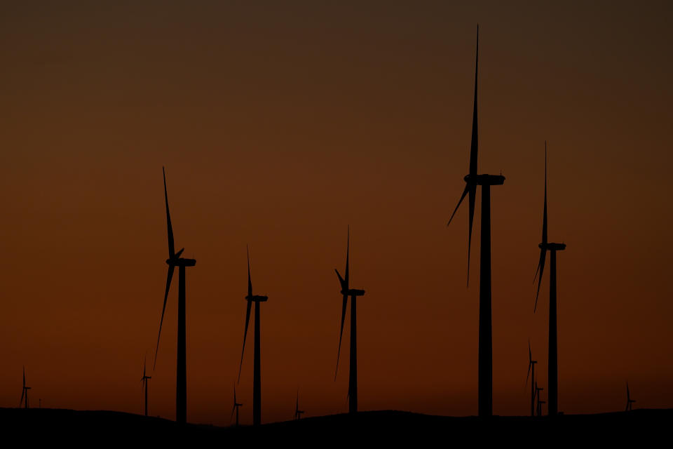 Wind turbines work in Livermore, Calif., Wednesday, Aug. 10, 2022. Congress is poised to pass a transformative climate change bill on Friday, Aug. 12. The crux of the long-delayed bill is to use incentives to accelerate the expansion of clean energy such as wind and solar power, speeding the transition away from the oil, coal and gas that largely cause climate change. (AP Photo/Godofredo A. Vásquez)