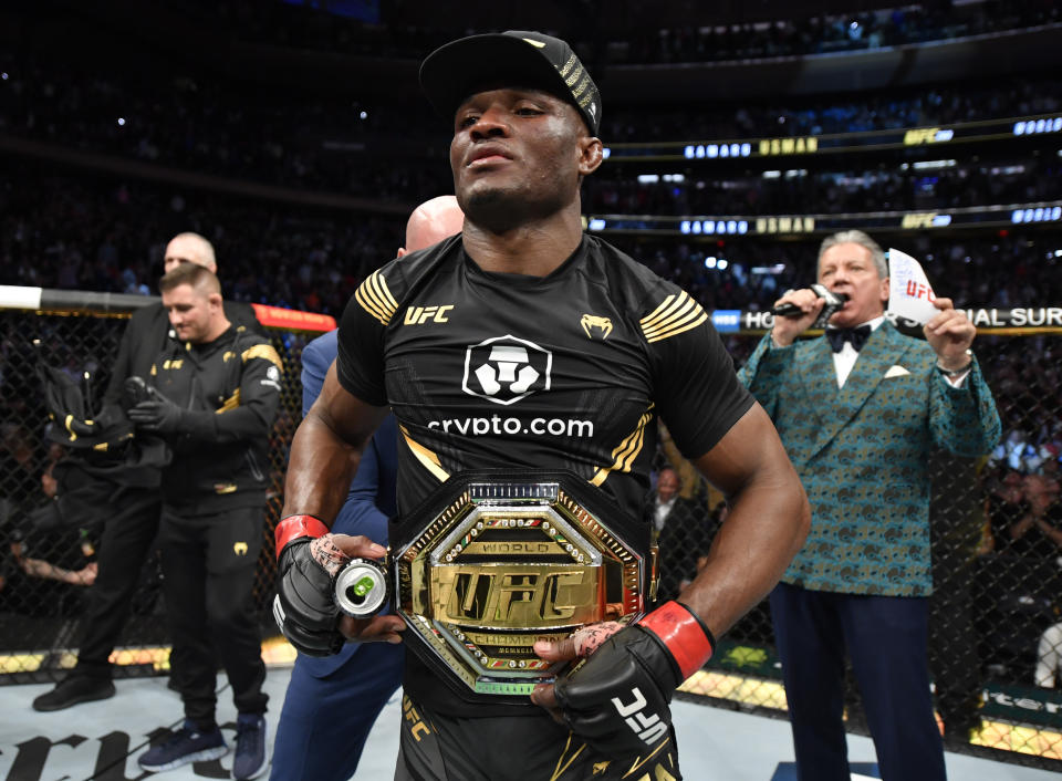 Kamaru Usman (pictured) celebrates as the belt is wrapped around him with the belt after his unanimous-decision victory over Colby Covington.