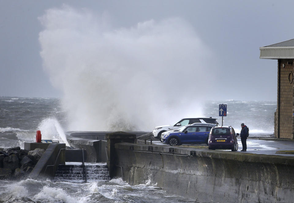 Waves batter the coastline at Saltcoats, North Ayrshire, Scotland, Sunday, Feb. 9, 2020. Trains, flights and ferries have been cancelled and weather warnings issued across the United Kingdom as a storm with hurricane-force winds up to 80 mph (129 kph) batters the region. (Andrew Milligan/PA via AP)