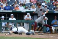 Jun 19, 2018; Omaha, NE, USA; Mississippi State Bulldogs left fielder Rowdey Jordan (4) scores as North Carolina Tar Heels catcher Brandon Martorano (4) can't handle a throw in the eighth inning in the College World Series at TD Ameritrade Park. Mandatory Credit: Steven Branscombe-USA TODAY Sports