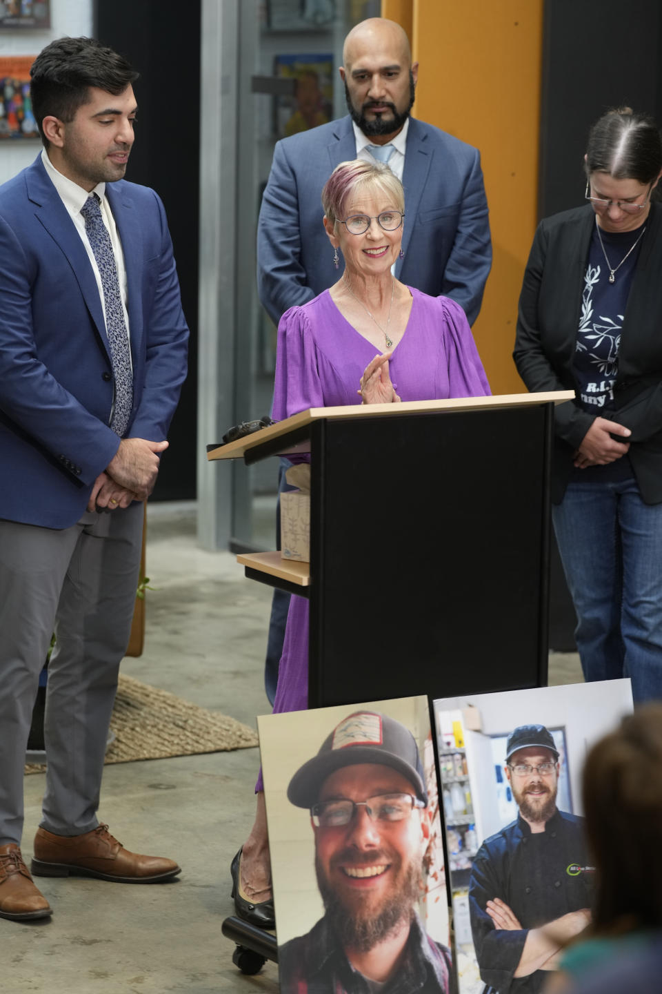 Kathleen Boleyn, front center, mother of man who was fatally shot by a police officer from the Arvada, Colo., Police Department in June 2021, talks about the $2.8-million settlement reached with the northwest Denver suburban city Thursday, Sept. 28, 2023, in Denver. Boleyn's son, Johnny Hurley, was shot after he had killed an active shooter who had killed an Arvada officer in the city's Olde Town area on June 21, 2021. Looking are are, from back left, attorneys Omeed Azmoudeh and Qusair Mohamedbhai and Boleyn's daughter, Erin Hurley. (AP Photo/David Zalubowski)