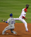 ST LOUIS, MO - OCTOBER 27: Mike Napoli #25 of the Texas Rangers rolls his ankle sliding into second base ahead of Rafael Furcal #15 of the St. Louis Cardinals after a throwing error in the fourth inning during Game Six of the MLB World Series at Busch Stadium on October 27, 2011 in St Louis, Missouri. (Photo by Doug Pensinger/Getty Images)