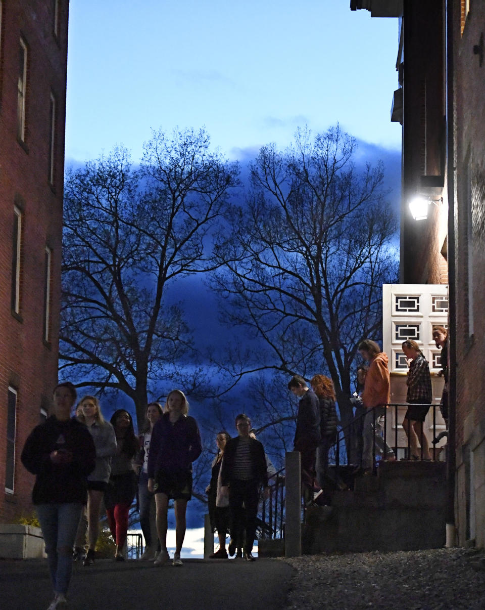 Students walk out of Johnson Chapel, where former attorney general Jeff Sessions is speaking, at Amherst College in Amherst, Mass., Wednesday, April 24, 2019. (AP Photo/Jessica Hill)