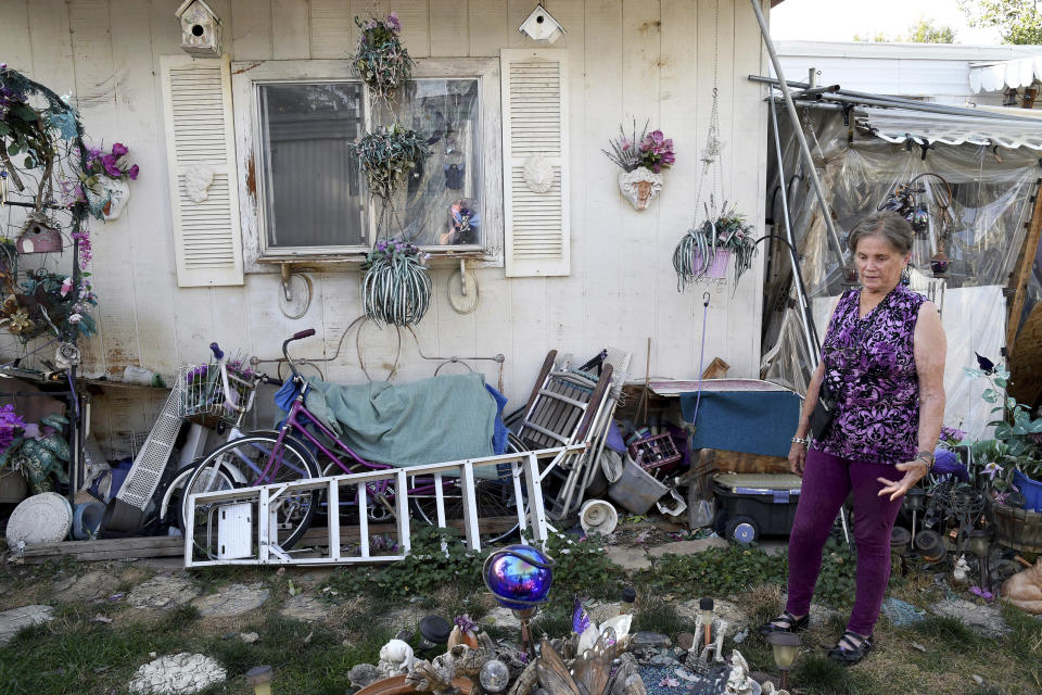 ADVANCE ON THURSDAY, SEPT. 12 FOR USE ANY TIME AFTER 3:01 A.M. SUNDAY SEPT 15 Doretta Hultquist looks at decorations in her yard at the San Souci Mobile Home Park south of Boulder, Colo., on Saturday, Aug. 31, 2019. Residents say that after Colorado-based RV Horizons bought the property in 2018, rents were raised, the company started charging residents for well water and strict rules were put in place governing anything from lawn care to what kind of curtains can be hung. (AP Photo/Thomas Peipert)