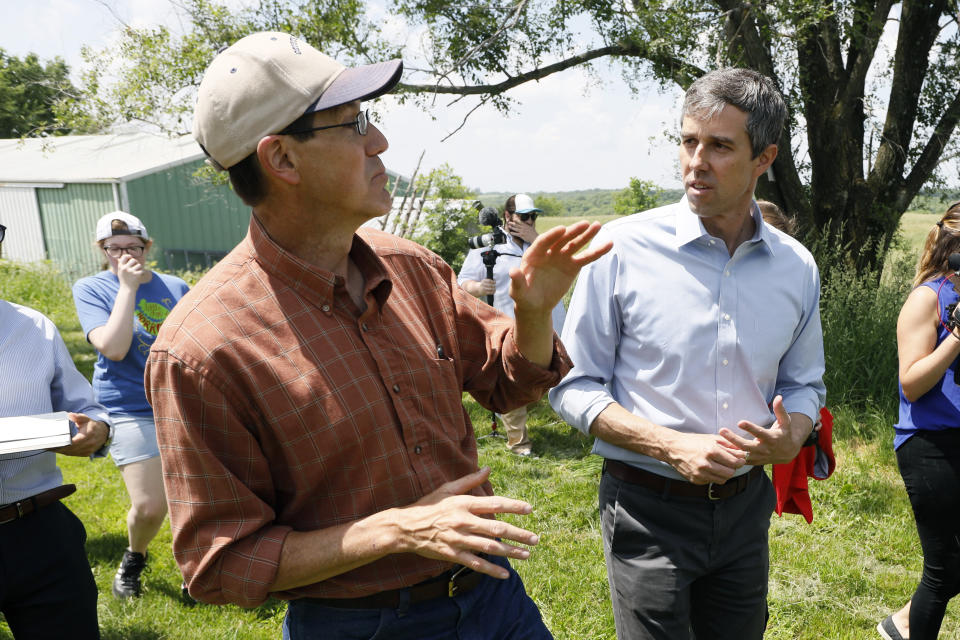 Democratic presidential candidate Beto O'Rourke talks with Matt Russell, left, while touring his Coyote Run Farm, Friday, June 7, 2019, in Lacona, Iowa. (AP Photo/Charlie Neibergall)