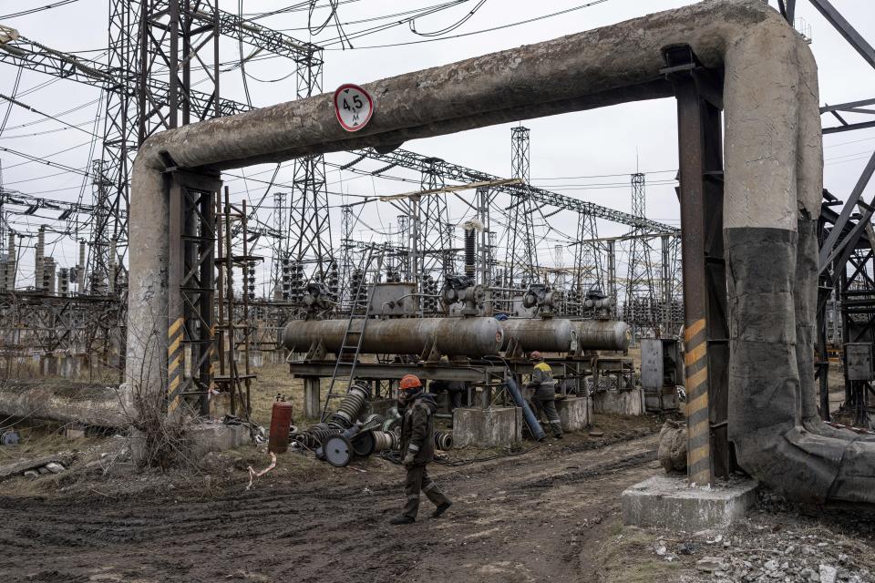 Workers at a power plant, try to repair damages after a Russian attack in central Ukraine, Thursday, Jan. 5, 2023. When Ukraine was at peace, its energy workers were largely unheralded. War made them heroes. They're proving to be Ukraine's line of defense against repeated Russian missile and drone strikes targeting the energy grid and inflicting the misery of blackouts in winter. (AP Photo/Evgeniy Maloletka)