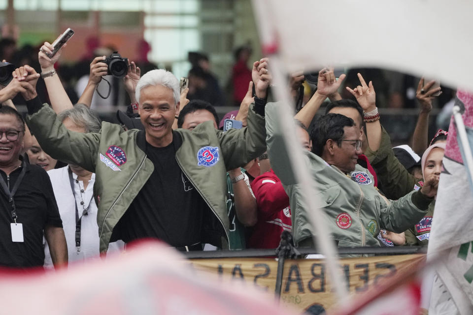 Presidential candidate Ganjar Pranowo, left, and his running mate Mahfud MD gesture during a campaign rally at Gelora Bung Karno Main Stadium in Jakarta, Indonesia, Saturday, Feb. 3, 2024. The world's third-largest democracy is scheduled to hold its parliamentary and presidential elections on Feb. 14, 2024.(AP Photo/Achmad Ibrahim)