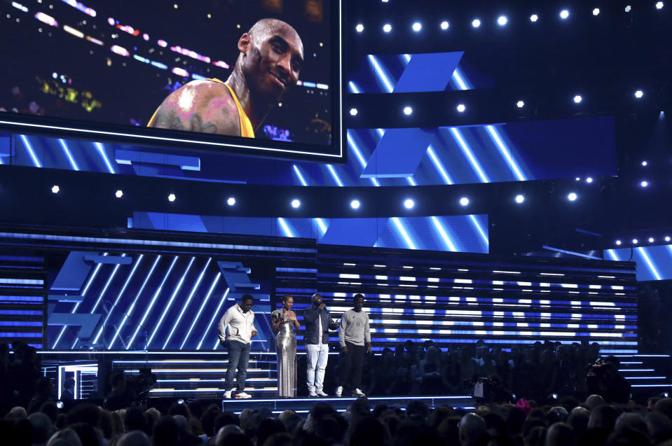 Alicia Keys, second left, and members of Boys II Men, from left, Nathan Morris, Wanya Morris and Shawn Stockman, sing "It's So Hard to Say Goodbye to Yesterday" during a tribute to the late Kobe Bryant, seen on screen, at the 62nd annual Grammy Awards on Sunday, Jan. 26, 2020, in Los Angeles. (Photo by Matt Sayles/Invision/AP)