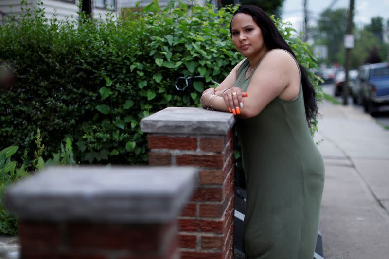 Gabby Niziolek poses for a photograph in front of her home in Elizabeth, New Jersey