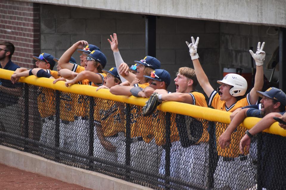 Mooresville's dugout celebrates as Judah Hennessy hits a home run during the Pioneers' regional game with Columbus East on June 4, 2022.