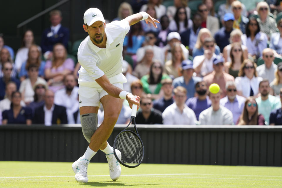 Serbia's Novak Djokovic plays a forehand return to Britain's Jacob Fearnley during their second round match at the Wimbledon tennis championships in London, Thursday, July 4, 2024. (AP Photo/Kirsty Wigglesworth)