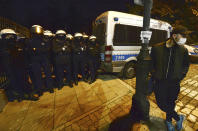 A police cordon guards the house of Poland's ruling conservative party leader Jaroslaw Kaczynski against a crowd protesting a decision by the Constitutional Court, in Warsaw, Poland, on Friday, Oct. 23, 2020. Poland’s top court ruled Thursday that a law allowing abortion of fetuses with congenital defects is unconstitutional, shutting a major loophole in the predominantly Catholic country's abortion laws that are among the strictest in Europe. Defying the pandemic-related ban on gatherings, the protesters chanted for the government to resign. (AP Photo/Czarek Sokolowski)